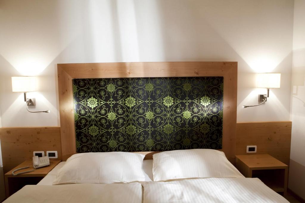 Postel nebo postele na pokoji v ubytování Hotel Christian