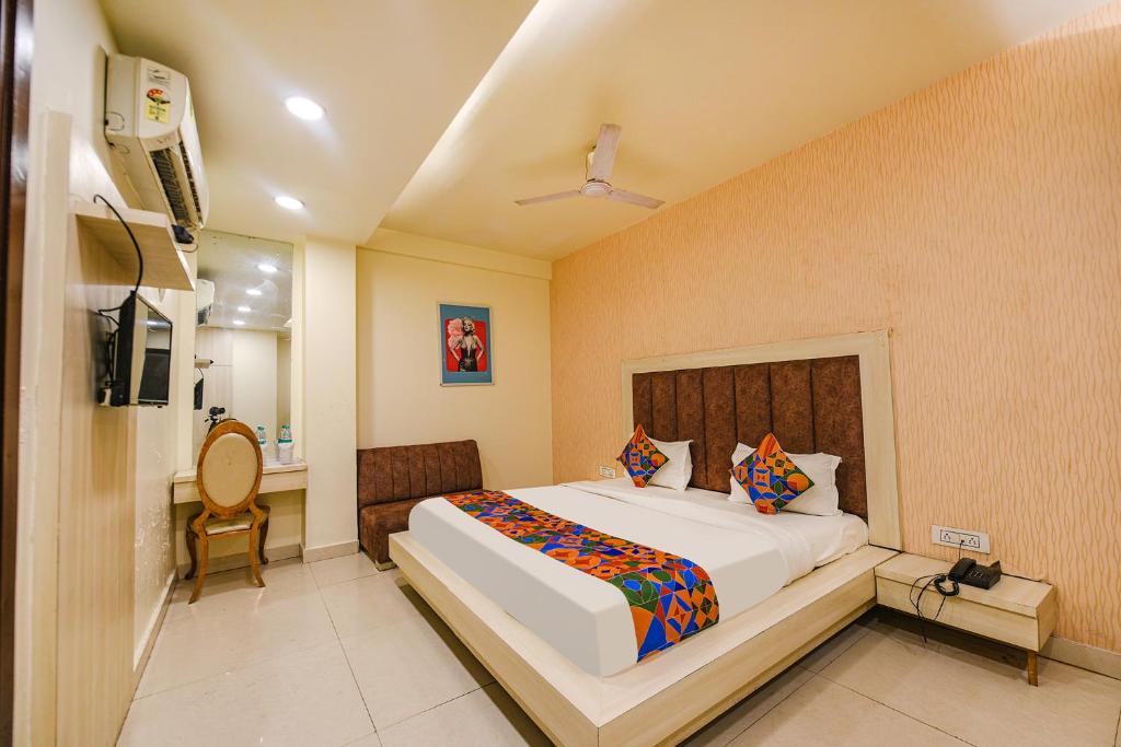 a bedroom with a large bed in a room at FabExpress Seven Heaven in New Delhi