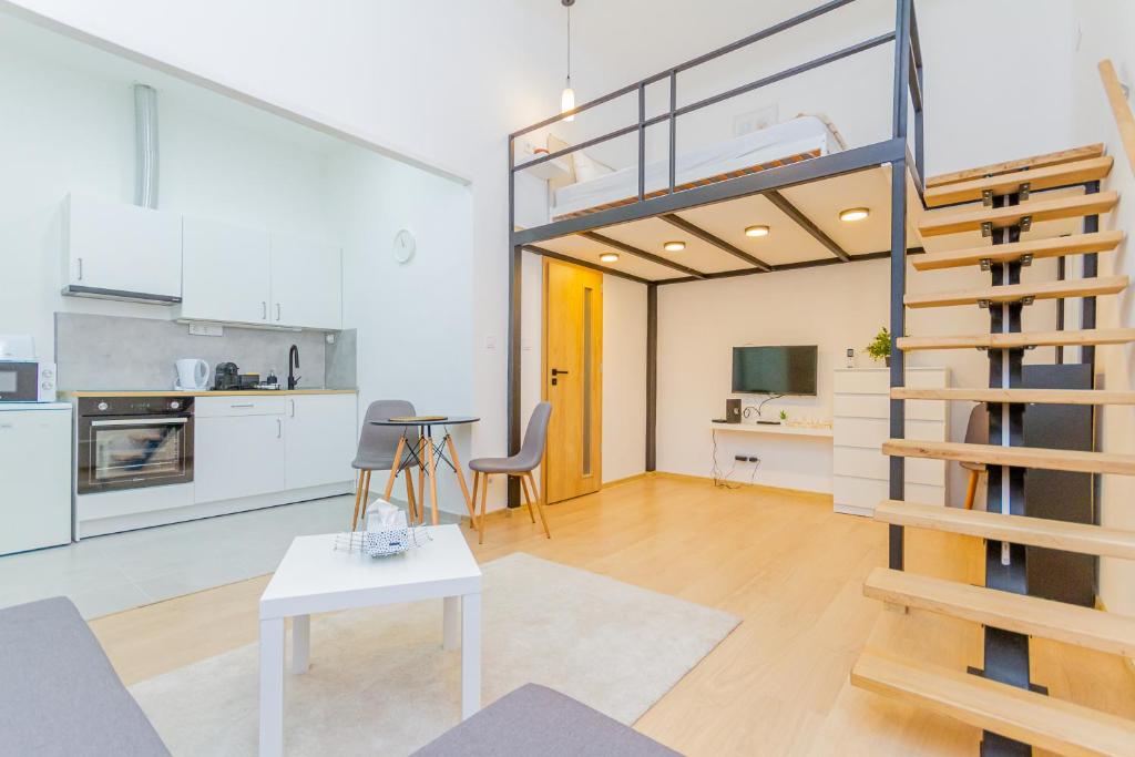 a kitchen and a living room with a loft at Eszter's cozy apartment in Budapest