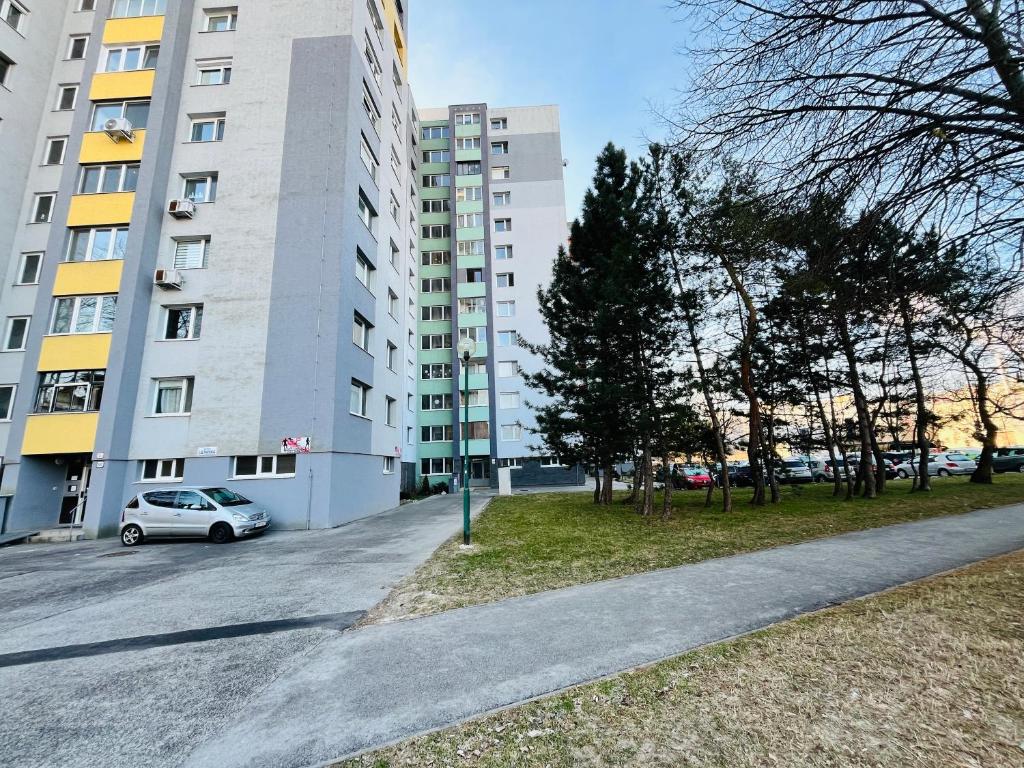 a car parked in front of a tall building at Free Wifi - Harmony Hideaways in Bratislava