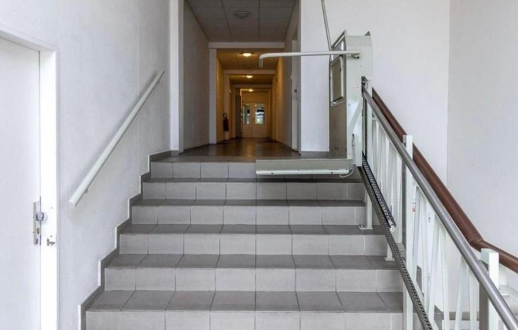 a stairway in a building with a hallway at Private apartment 1km from center in Nivy