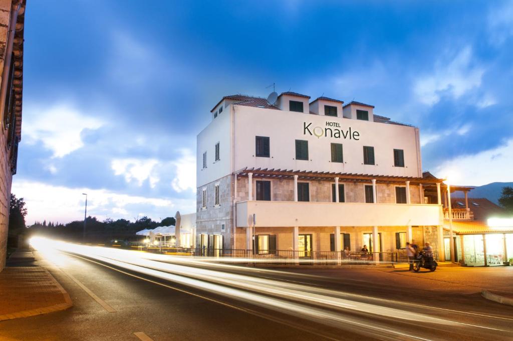 a building with the word kozy on the side of it at Hotel Konavle in Čilipi
