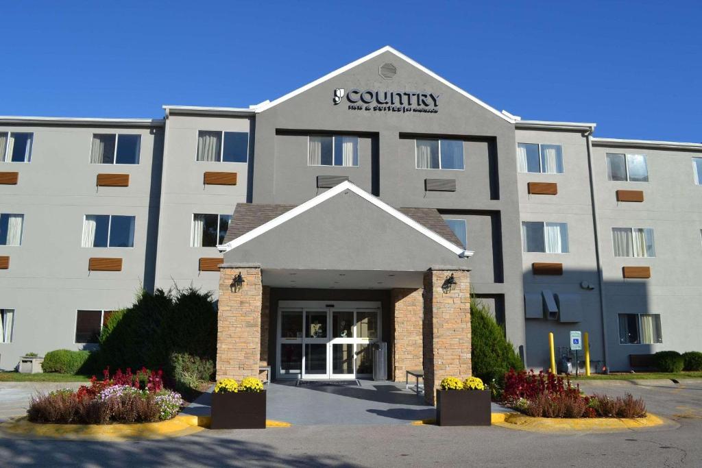 a large white building with a sign on it at Country Inn & Suites by Radisson, Fairview Heights, IL in Fairview Heights