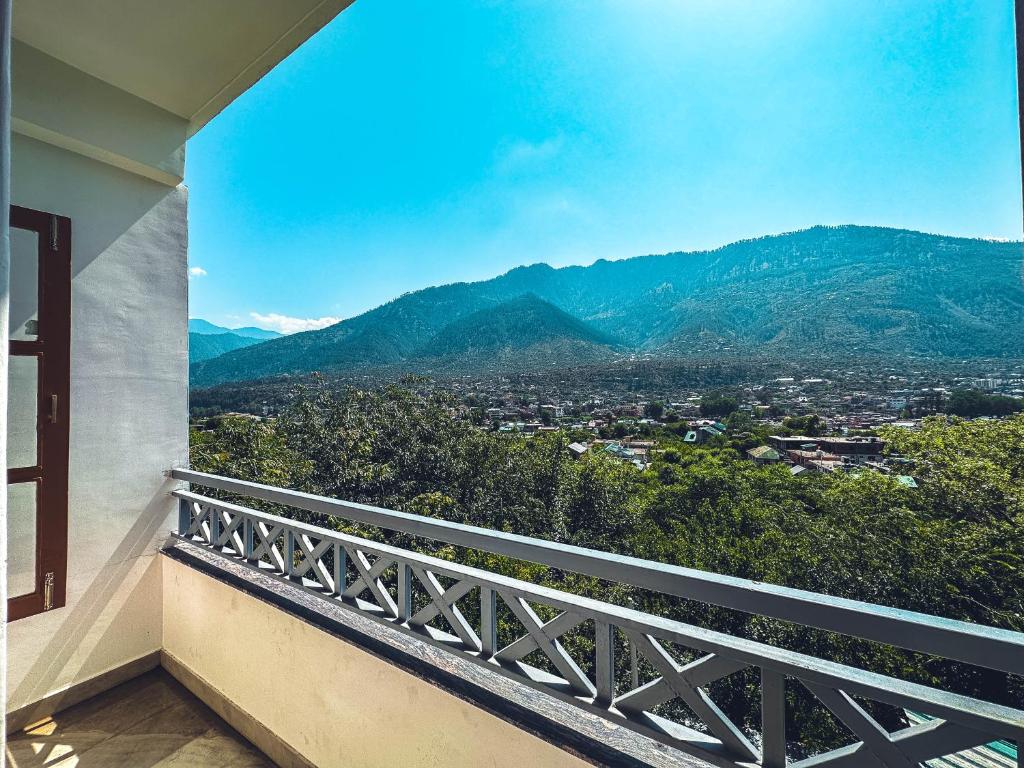 a balcony with a view of the mountains at Clover Inn by Offlimit Homes in Shamshi