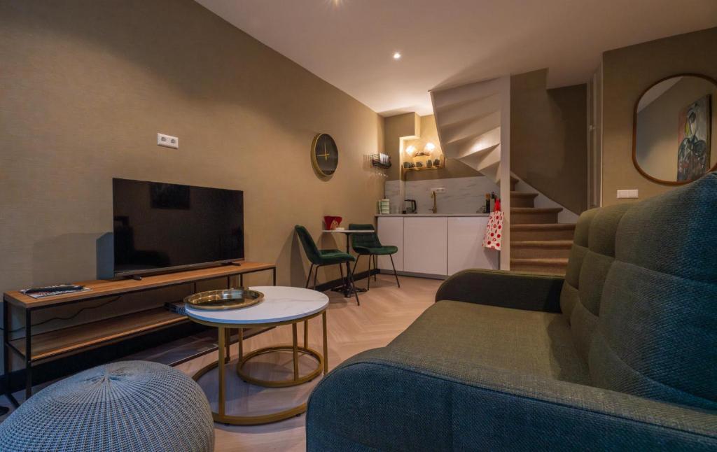 a living room with a couch and a tv at Downtown Suite in The Hague