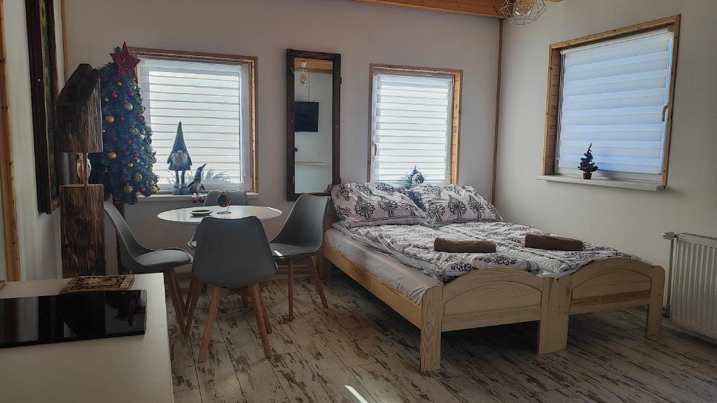 a bedroom with a bed and a table and chairs at U Bieńka in Biały Dunajec