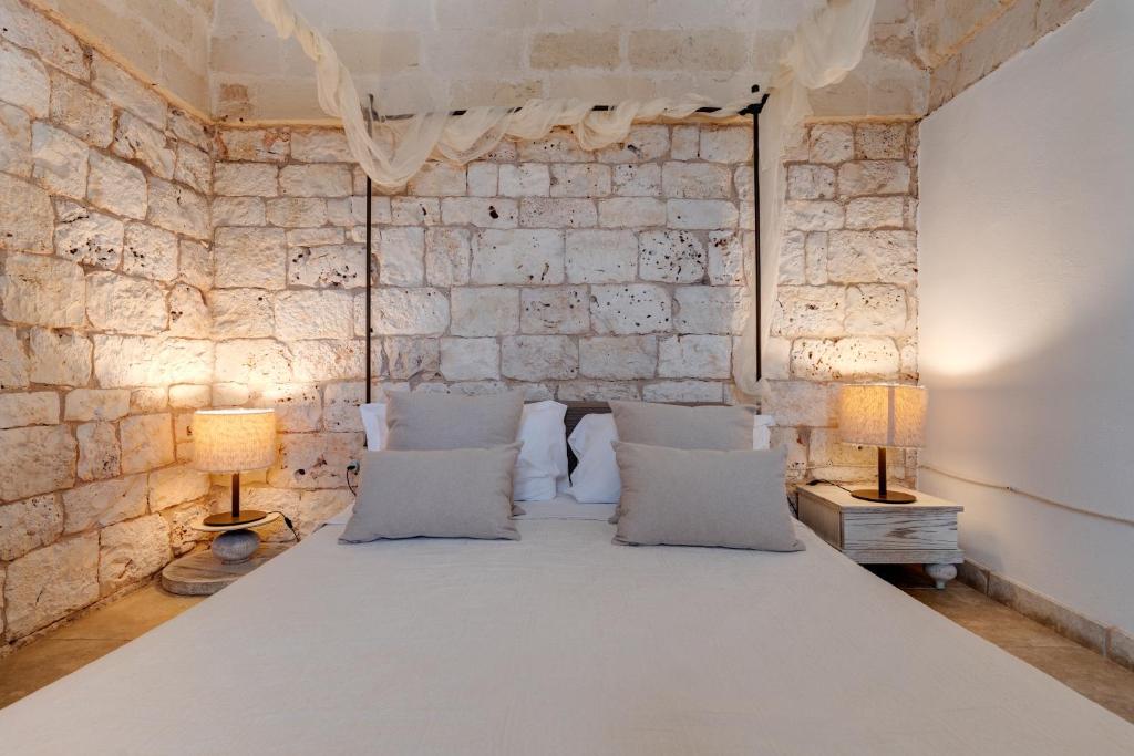 Postel nebo postele na pokoji v ubytování Relais Porta del Sud