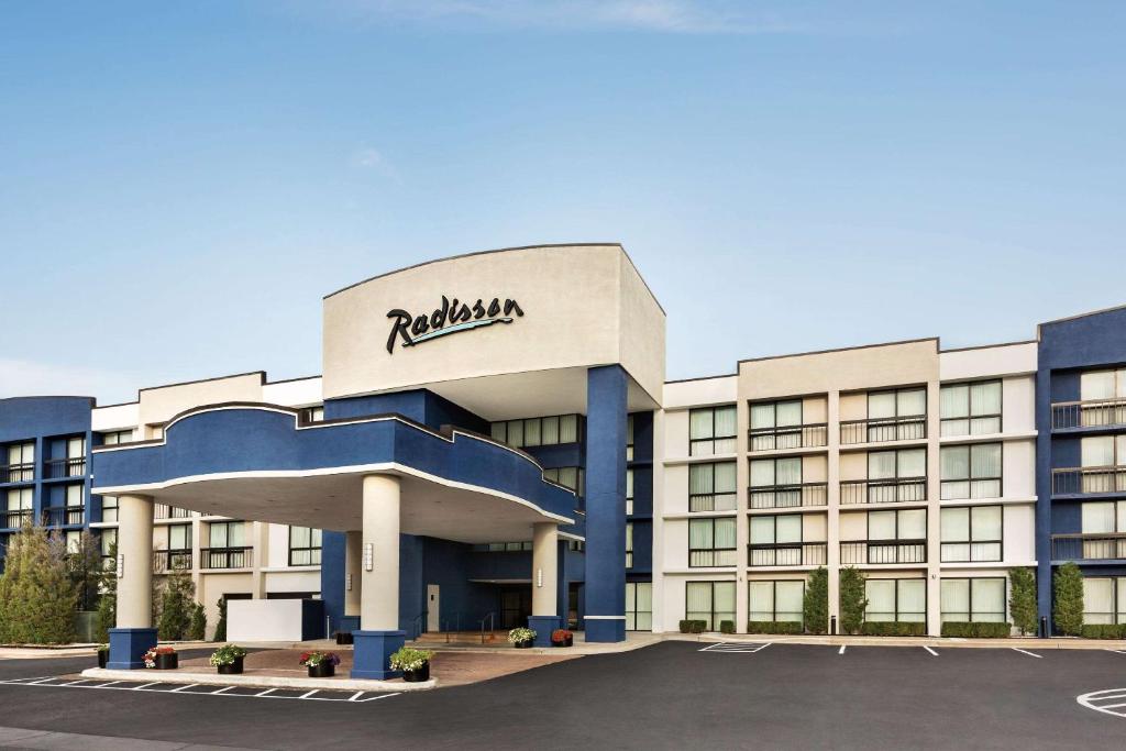 a building with a sign on the front of it at Radisson Hotel Lenexa Overland Park in Lenexa