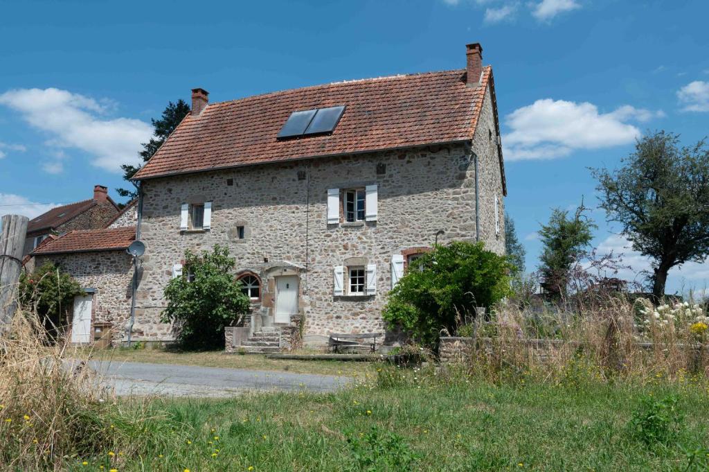 an old stone house with solar panels on the roof at La Terrade in Saint-Hilaire-La-Treille