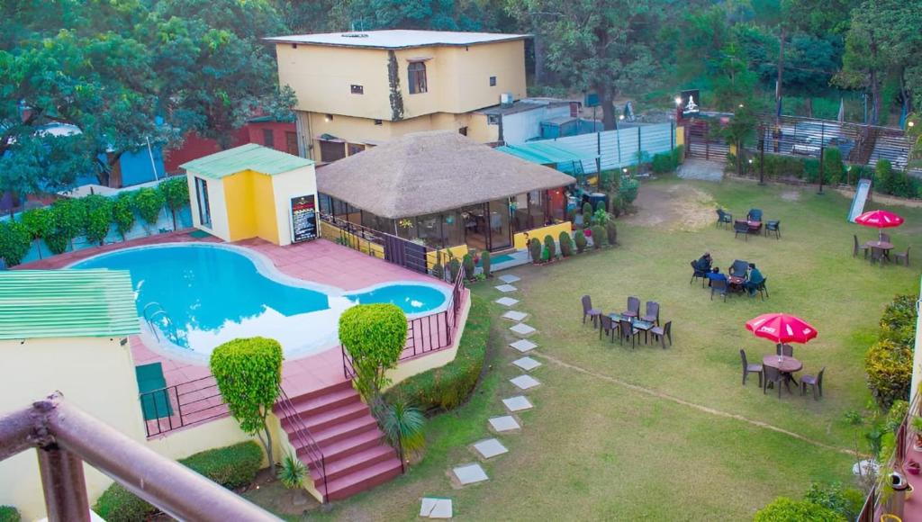 an aerial view of a resort with a swimming pool at Mannat Corbett Resort in Rāmnagar