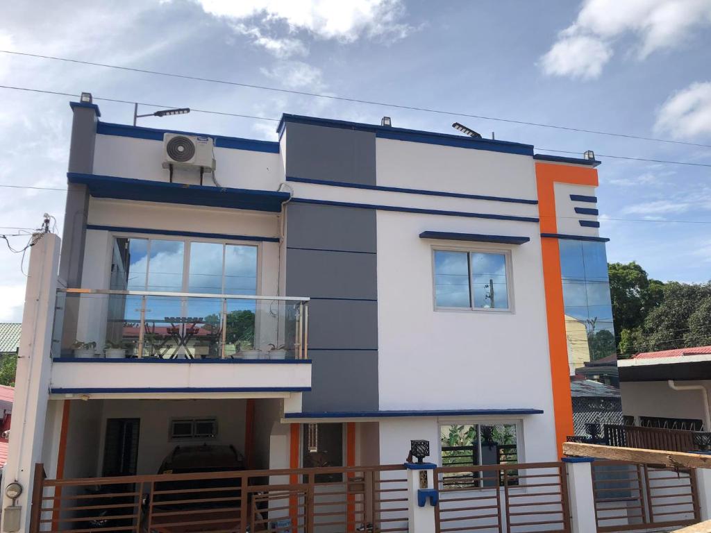 a white and blue house with a balcony at Jaleen Transient in Batangas City