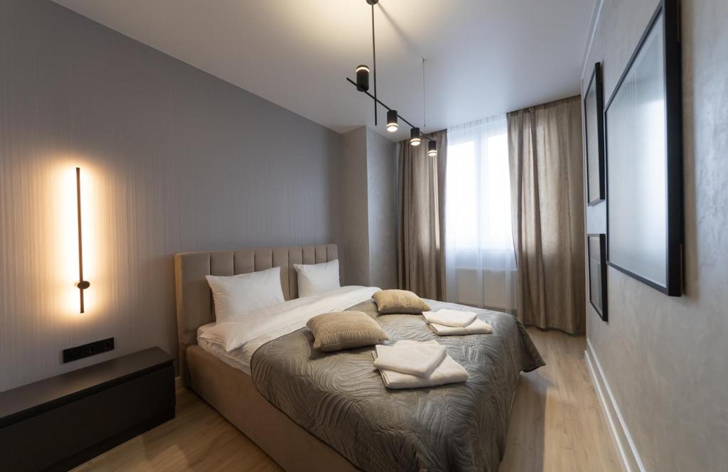 a bedroom with a bed with two pillows on it at MYFREEDOM Апартаменти ЖК NAVIGATOR in Kyiv