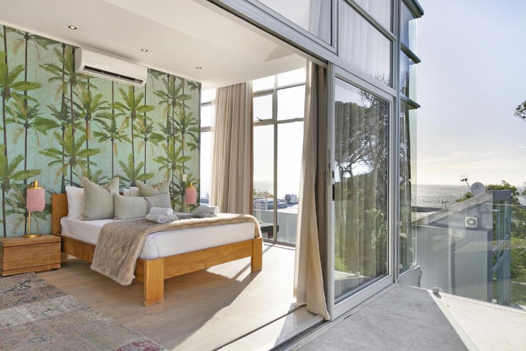 a bedroom with a bed and sliding glass doors at The Grange 11 in Cape Town