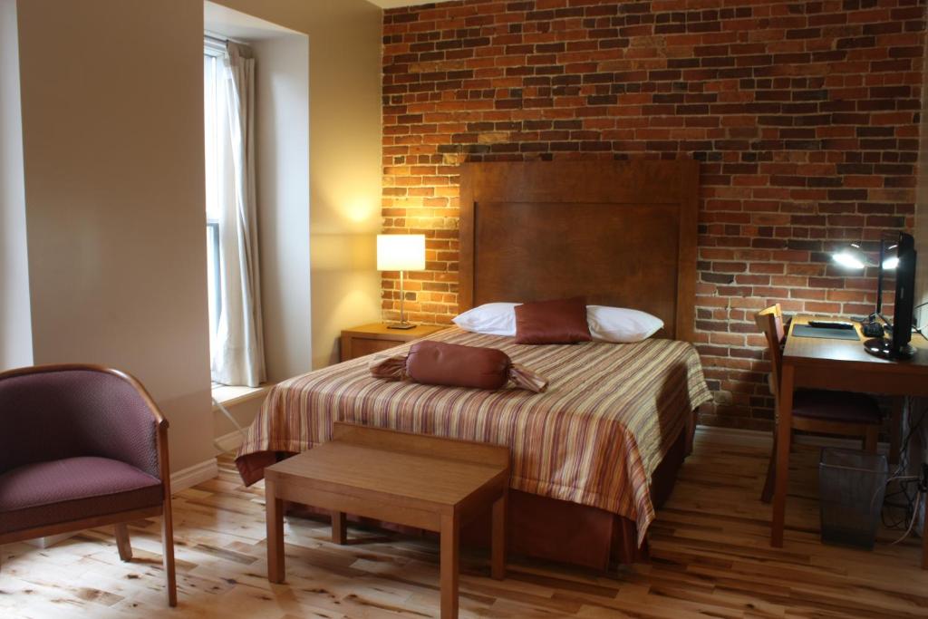 Postel nebo postele na pokoji v ubytování Hotel Abri du Voyageur