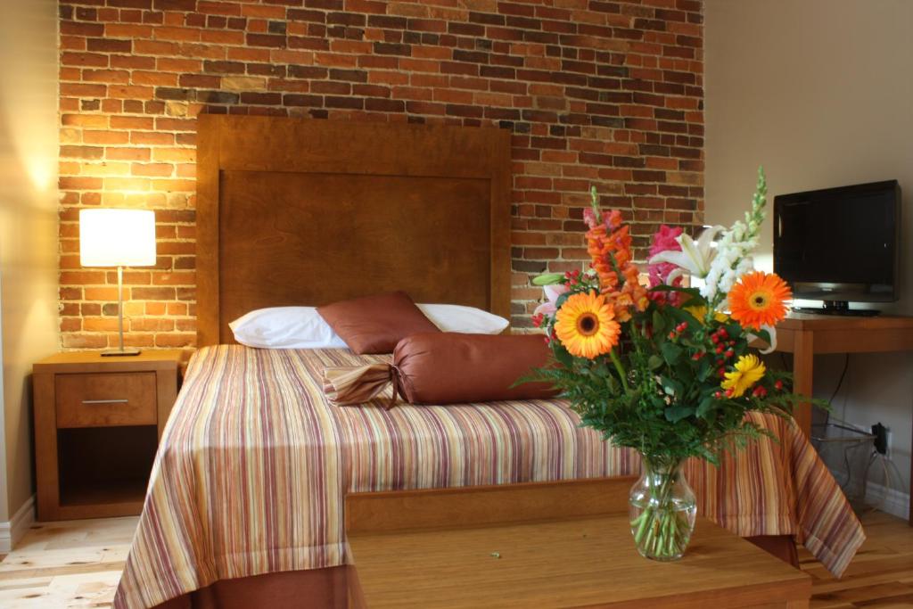 Postel nebo postele na pokoji v ubytování Hotel Abri du Voyageur
