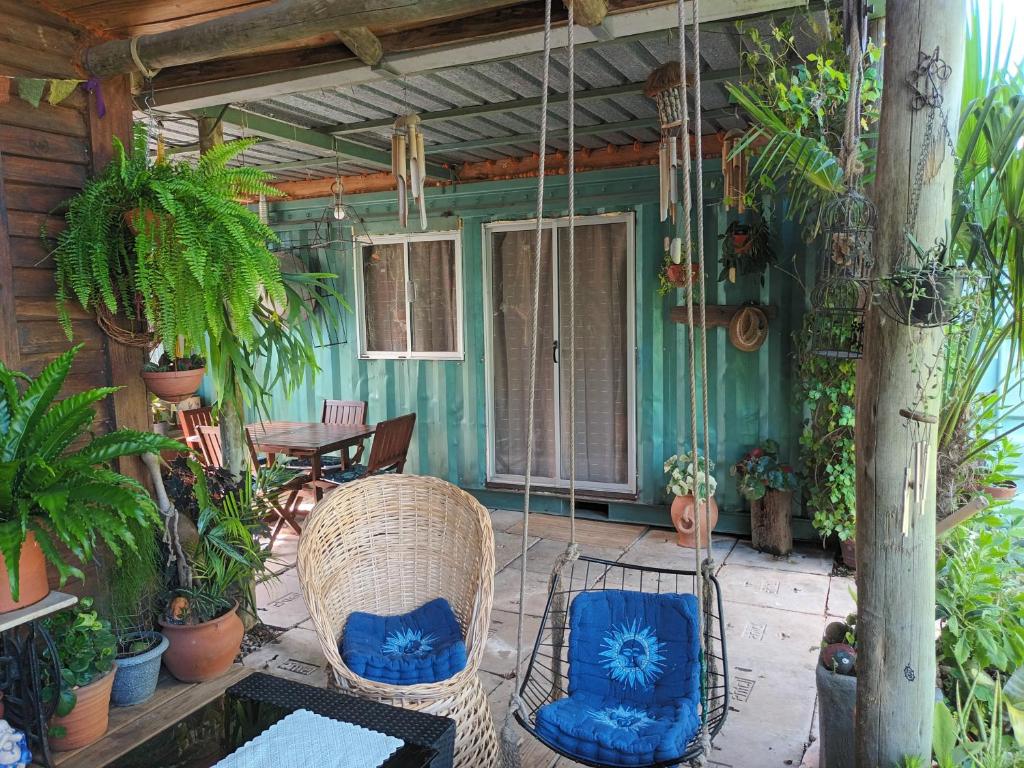 a porch of a house with chairs and plants at Leia's House in Colonia del Sacramento