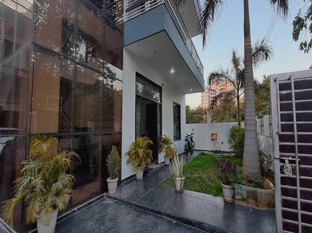 una casa con plantas en la parte delantera en OYO Naveen Residancy, en Gurgaon