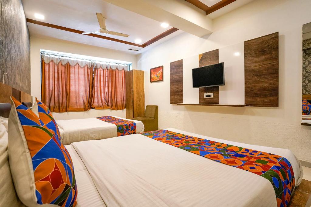 Postel nebo postele na pokoji v ubytování FabHotel Galaxy I
