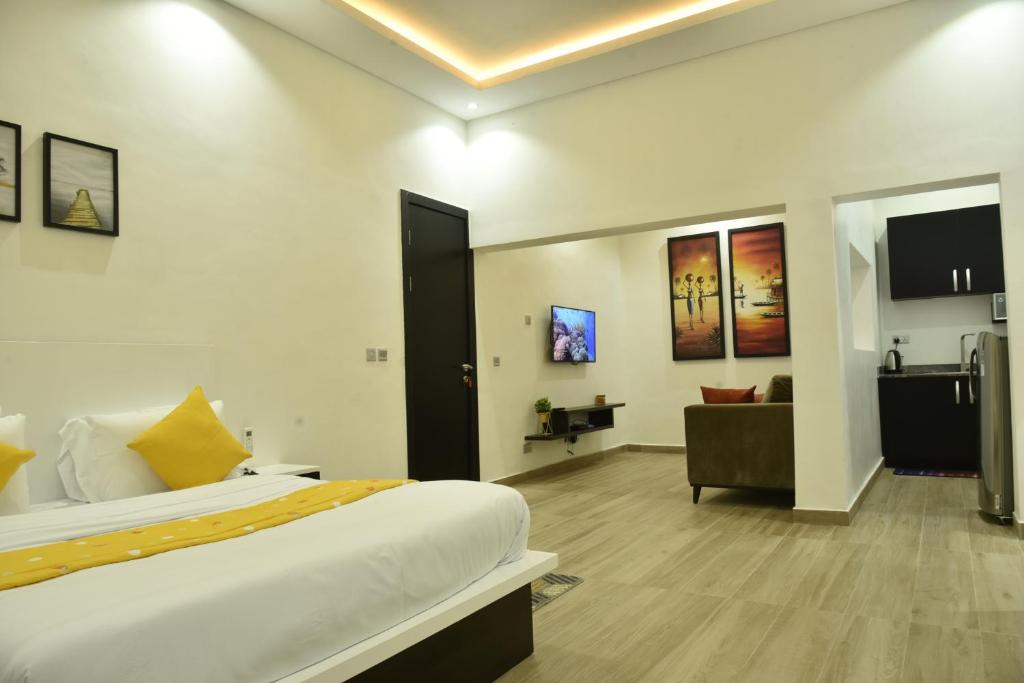 a bedroom with a bed and a living room at ABODE APARTMENTS in Lagos