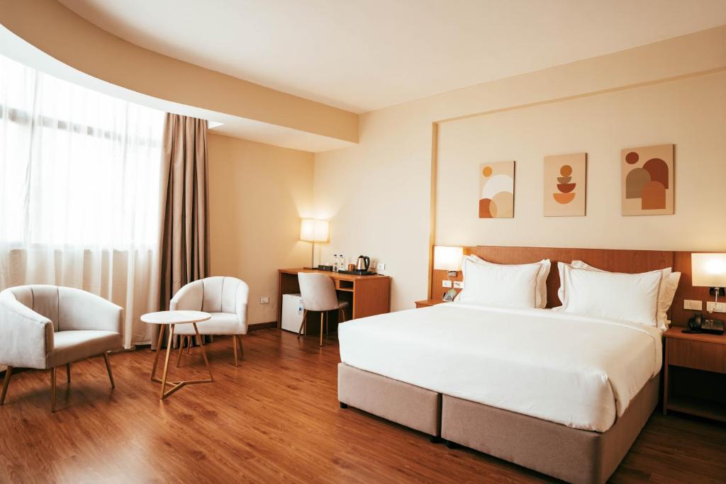 Ένα ή περισσότερα κρεβάτια σε δωμάτιο στο AYA Addis Hotel