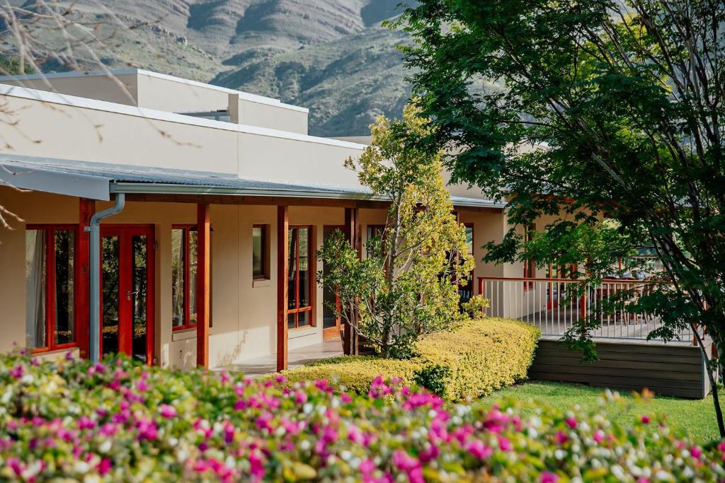 a house with pink flowers in front of it at Ontevreden Farm in Montagu