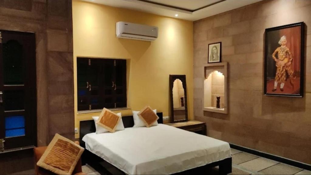 a bedroom with a bed and two mirrors at Hotel Sand Dunes Jodhpur in Jodhpur
