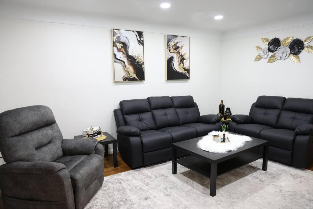 a living room with a couch and a chair and a table at Charming, Central, Cozy Home - Ideal in Dearborn Heights