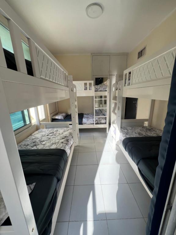 a room with two bunk beds in a house at Ramble Stay Hostel in Dubai