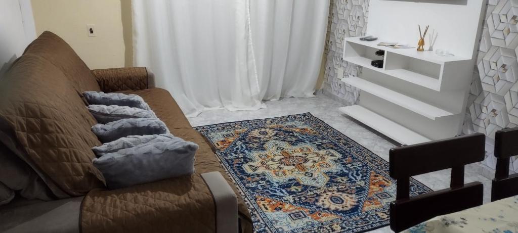 a living room with a couch and a rug at Apartamento 3 Dormitórios - Guarujá/SP - Lado Praia in Guarujá