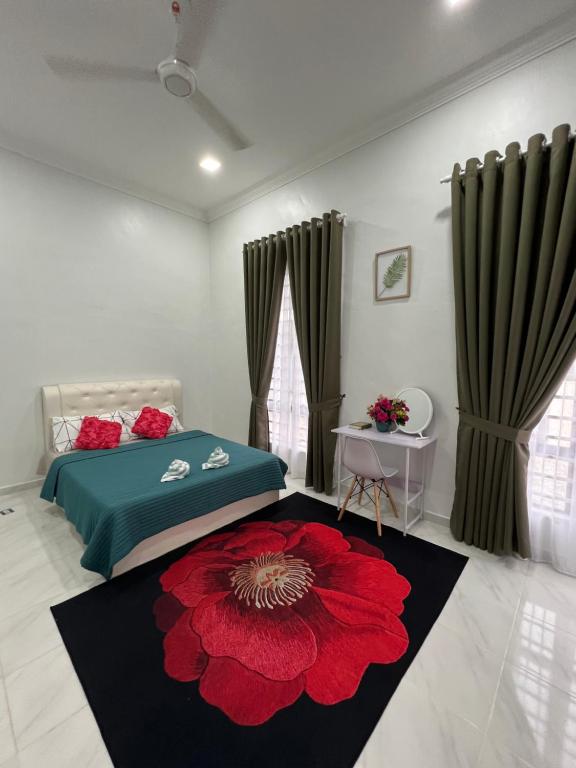 a bedroom with a bed and a red flower rug at Homestay Singgah Tamu Al Amin in Bukit Payong