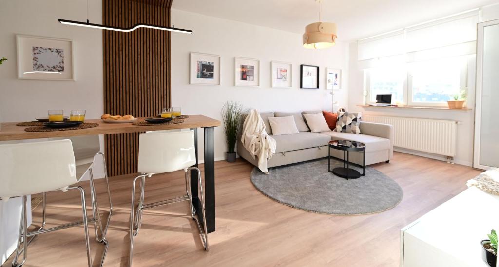 a living room with a table and a couch at Delux apartment LA ARENA with private garage in Zagreb