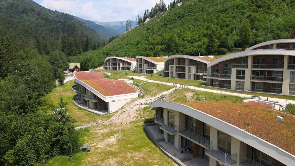 a group of buildings with a mountain in the background at Tále Apartmán E2 - Evergreen Tále in Tale