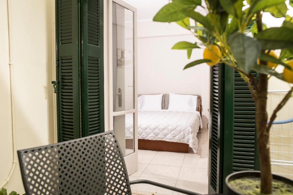 a room with a mirror and a chair and a bed at Historical center small diamond in Kalamata
