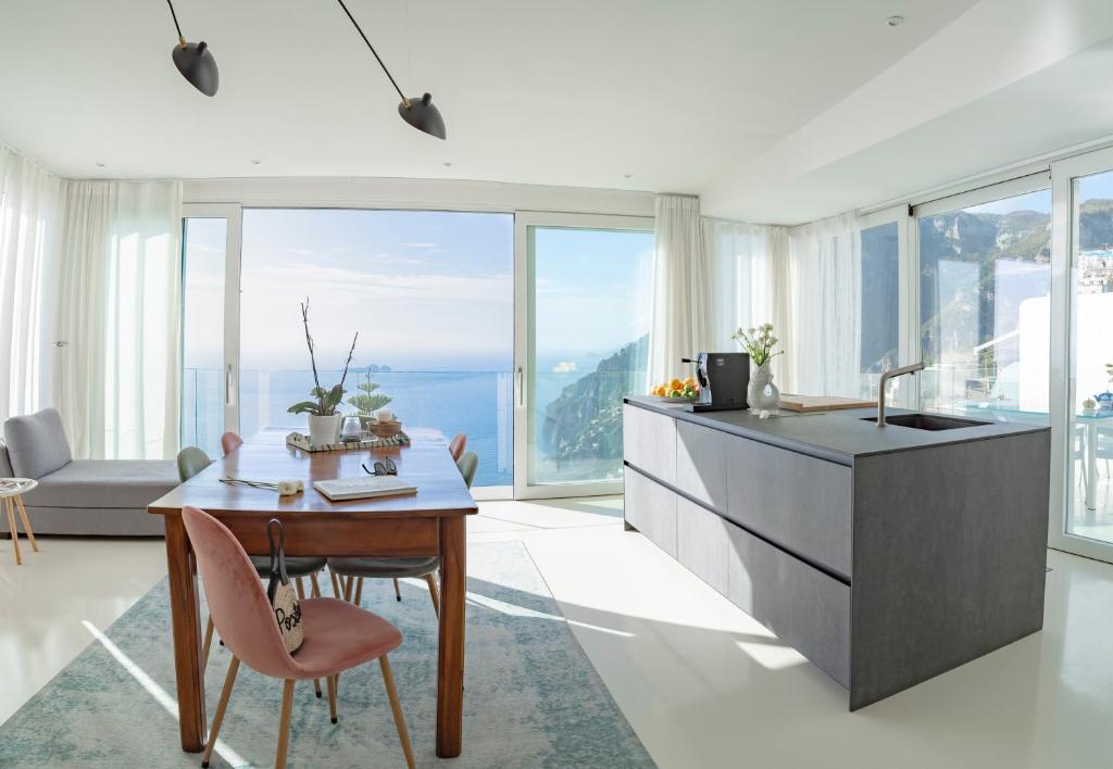 a kitchen and dining room with a table with a view at Casa Salvi Positano in Positano