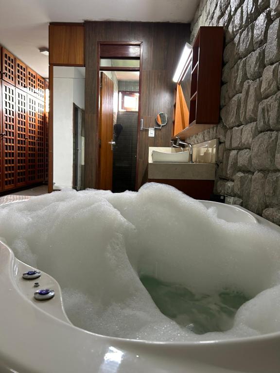 a bath tub covered in snow in a bathroom at Espaço Casa in Campina Grande