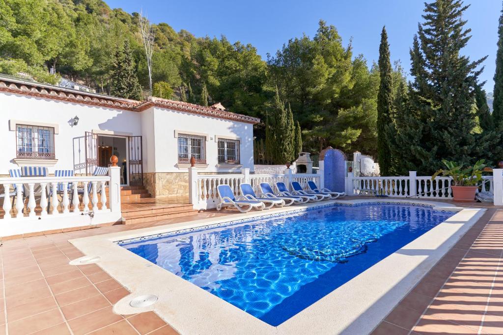 a villa with a swimming pool and a house at Villa Thomas in Frigiliana