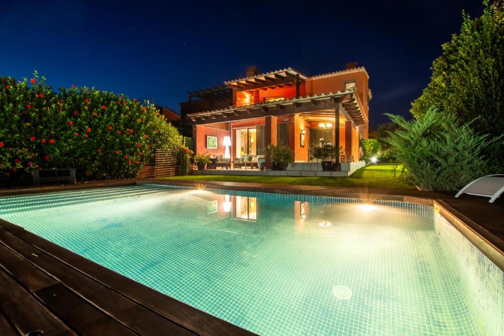 a swimming pool in front of a house at night at Villa Marimar - Private Pool in Bonmont Terres Noves