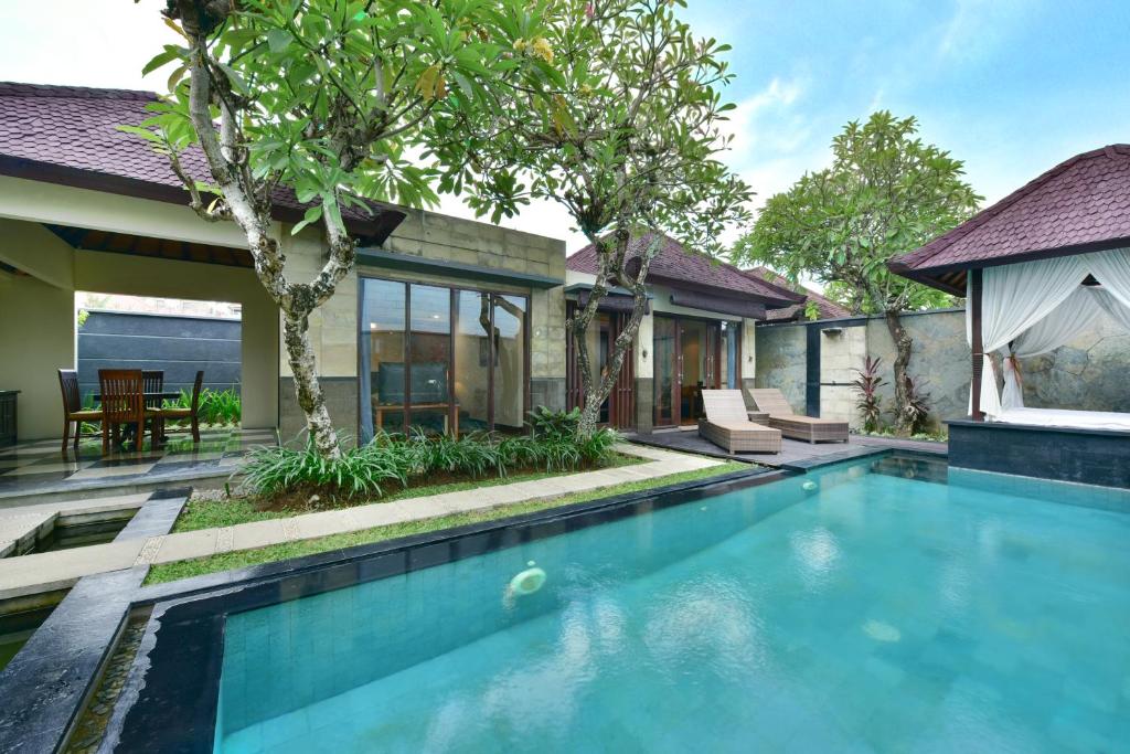 a swimming pool in the backyard of a house at The Khayangan Dreams Villa, Seminyak in Seminyak