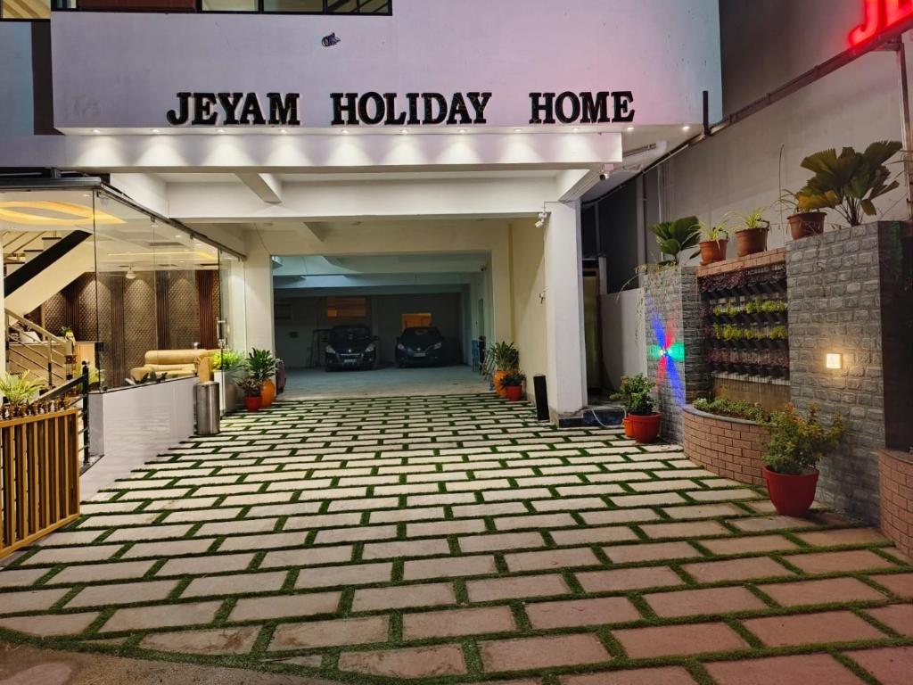 a hallway of a building with a sign that reads jason holiday home at JEYAM HOLIDAY HOME in Kanyakumari