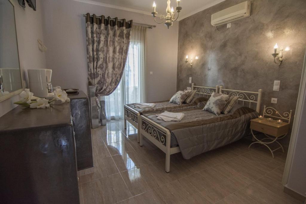 A bed or beds in a room at Polydefkis Hotel