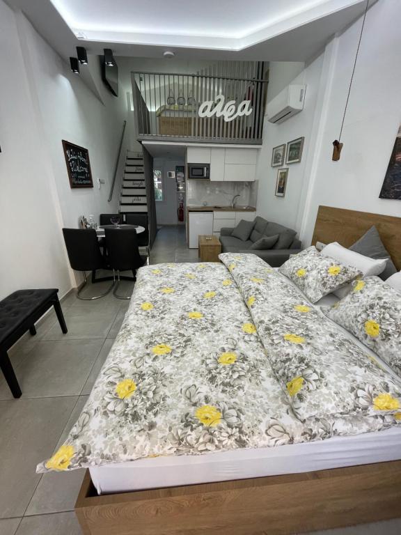 a bedroom with a large bed with yellow flowers on it at Alfa Studio in Kavála