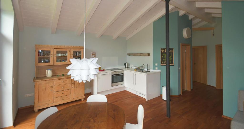 a kitchen with a table and a dining room at Ferienwohnung Vogelnest in Prien am Chiemsee