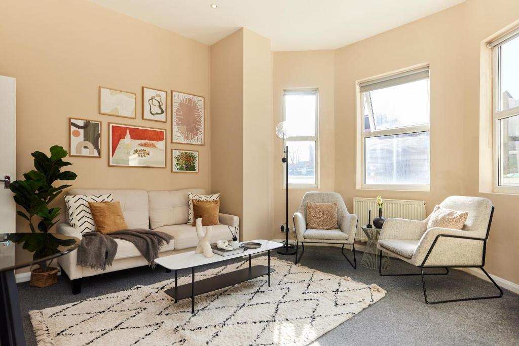 a living room with a couch and two chairs at The Crystal Palace Crib - Lovely 1BDR Flat in Crystal Palace