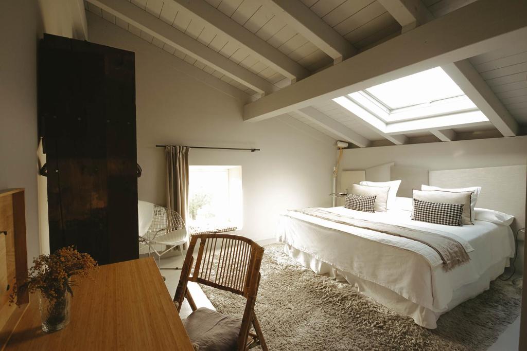 a bedroom with a large bed and a window at Hotel Garaiko Landetxea in Durango