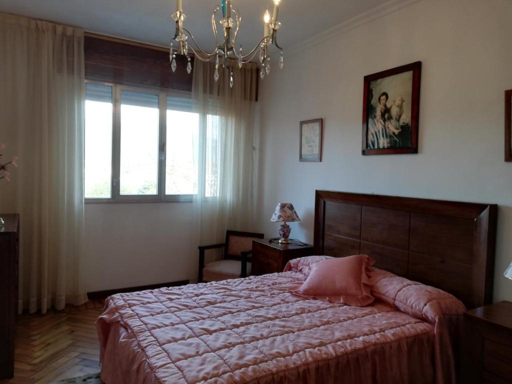 a bedroom with a large bed and a window at Casa Arcade in Sotomayor