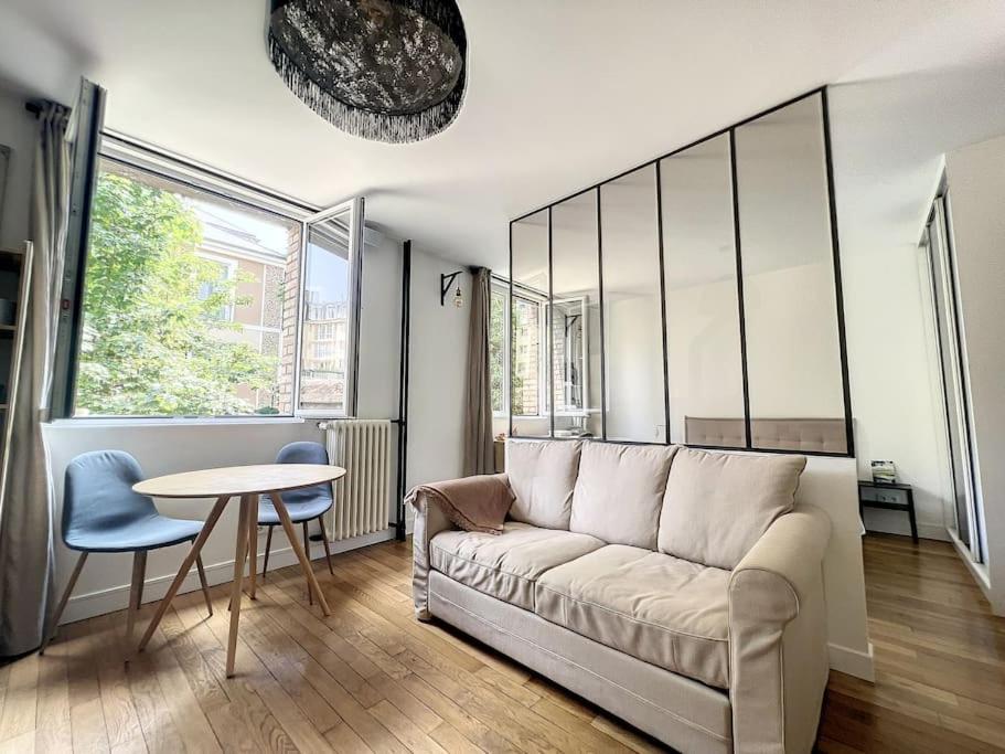 un salon avec un canapé et une table dans l'établissement Appartement refait à neuf à 2 min du Chateau, à Versailles