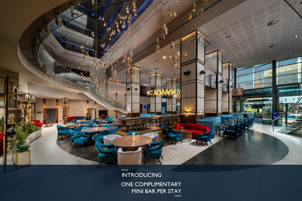 a restaurant with blue chairs and tables in a building at Radisson Blu Hotel Bucharest in Bucharest