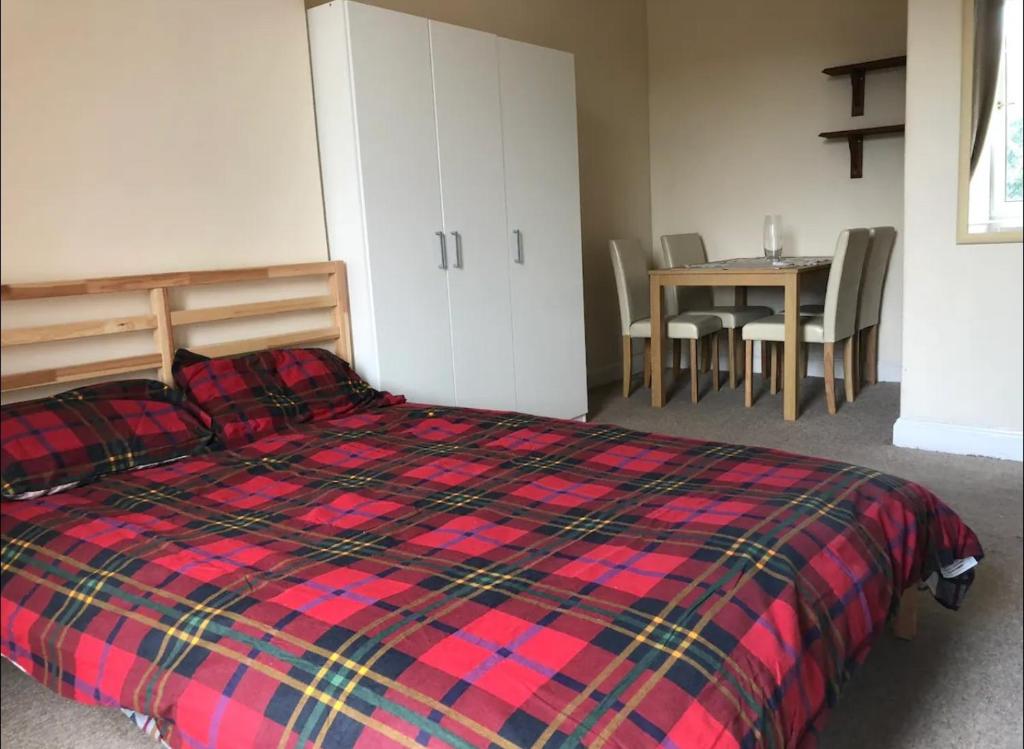 a bedroom with a bed and a table with chairs at Cosy, large double room in a shared flat in Edinburgh