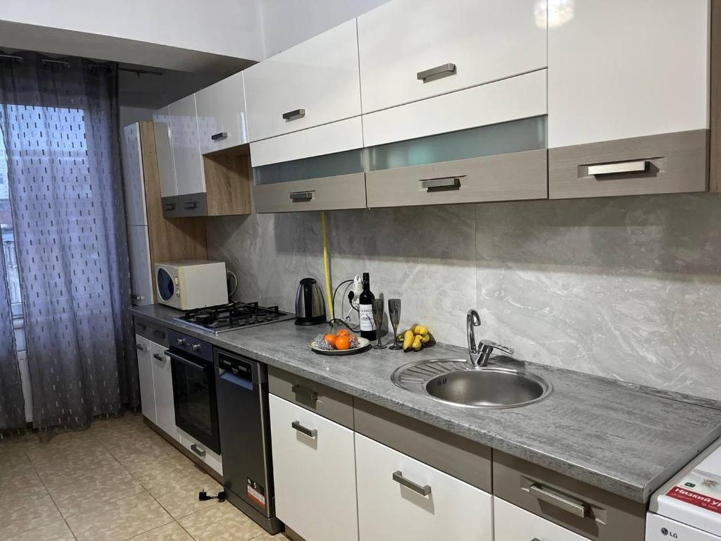 a kitchen with a sink and a counter top at Apartment for relax in Chişinău