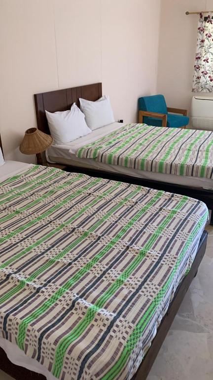 Кровать или кровати в номере Sayadeen Village - Red Sea Riviera